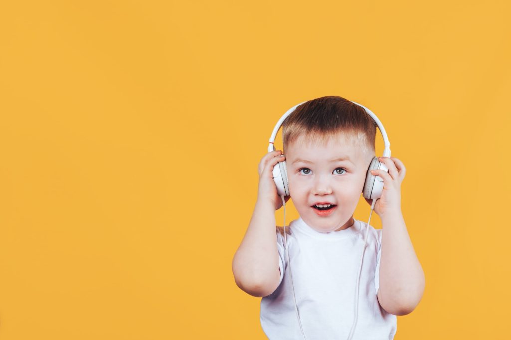 A boy actively listening to music with headphones for expression and meaning.