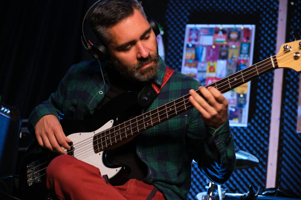 An electric bass student, who may be susceptible to perfectionism as an adult, is practicing.