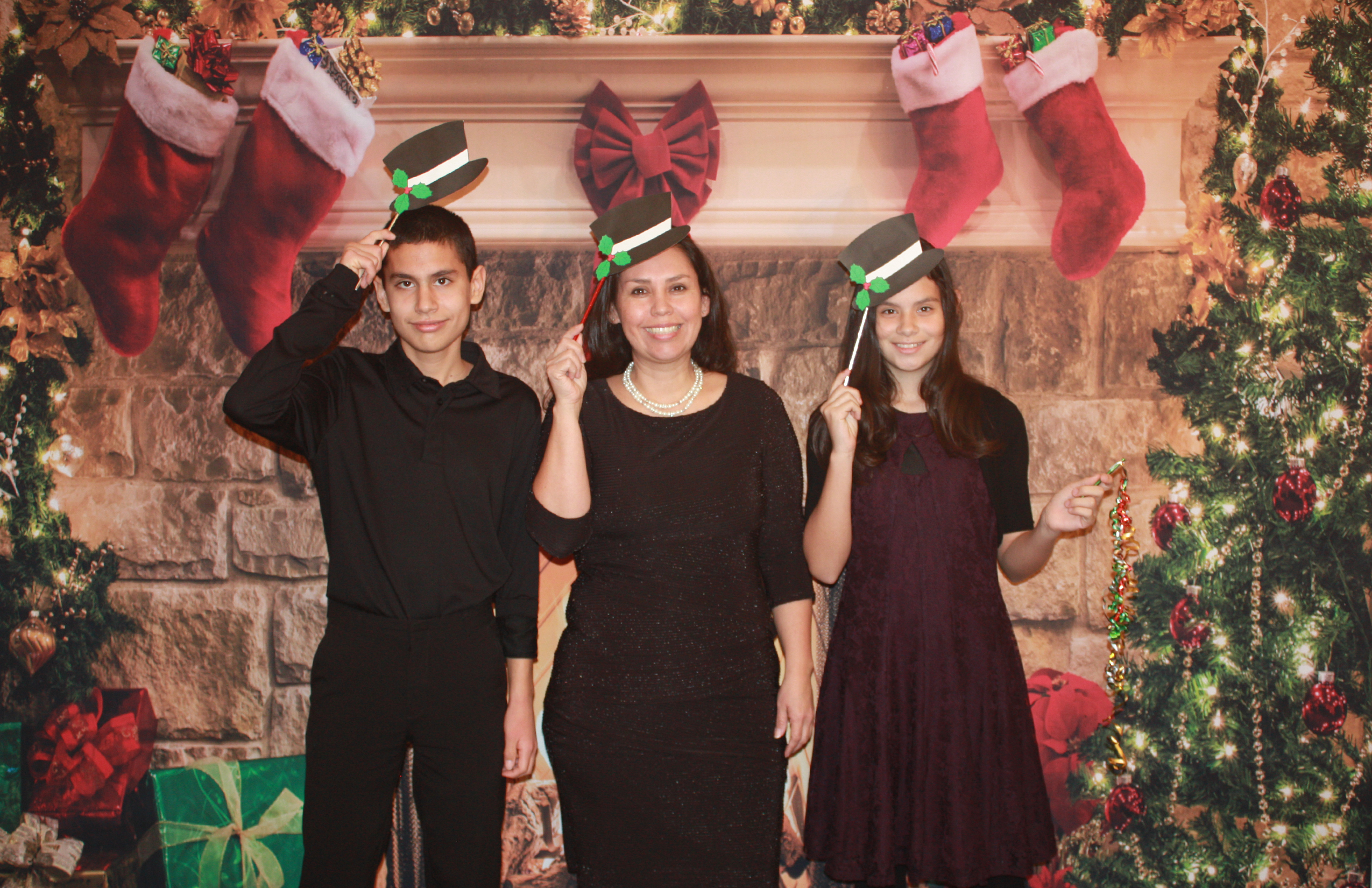 Performers posing after a Christmas recital with Christmas hats.