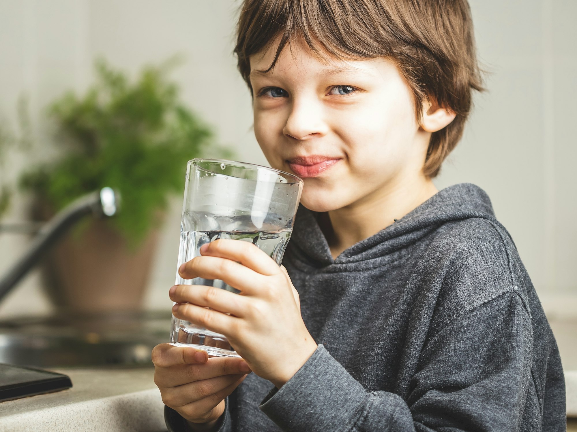 Little boy drinking water. Hydration helps the body function so it is part of a pre-memorization technique.