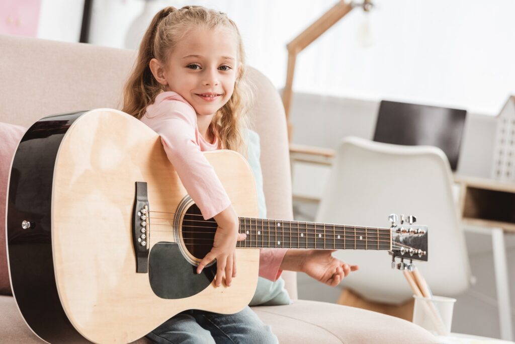 Young girl playing guitar for music contest